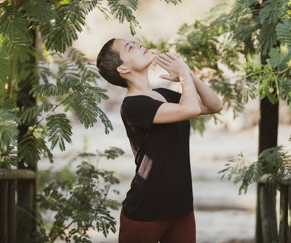 Person meditating peacefully in a beautiful natural setting.