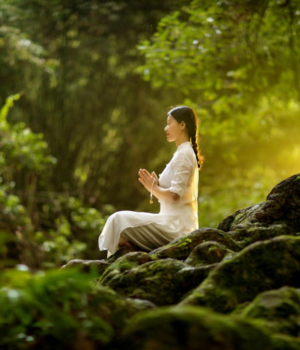 Woman holding a serene yoga pose in a calm environment.
